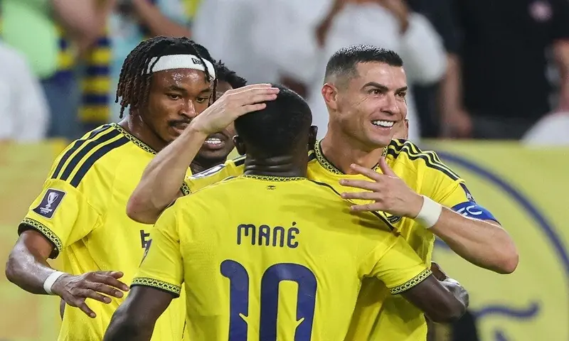 Al-Nassr's Cristiano Ronaldo (R) celebrates with team-mates after scoring against Neftchi Fergana during their AFC Champions League Group 'B' match at the Alawwal Park Stadium in Riyadh, Saudi Arabia, on October 12, 2026. &mdash;AFP
