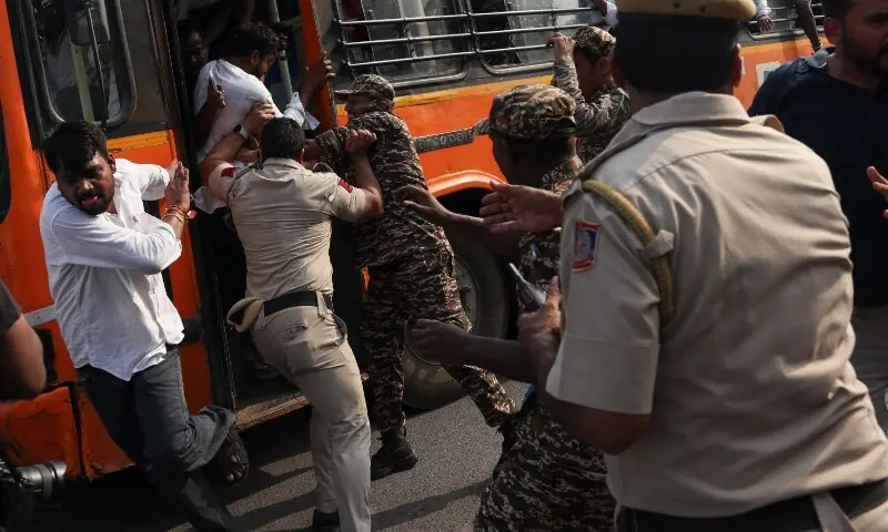 Security personnel try to prevent detained protesters from escaping from a bus during a protest demanding the resignation of India’s Chief Election Commissioner, Gyanesh Kumar, in New Delhi, India, October 13, 2026.—AFP