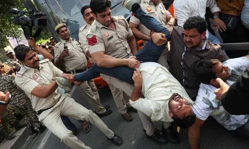 Security personnel try to prevent detained protesters from escaping from a bus during a protest demanding the resignation of India’s Chief Election Commissioner, Gyanesh Kumar, in New Delhi, India, October 13, 2026.—AFP