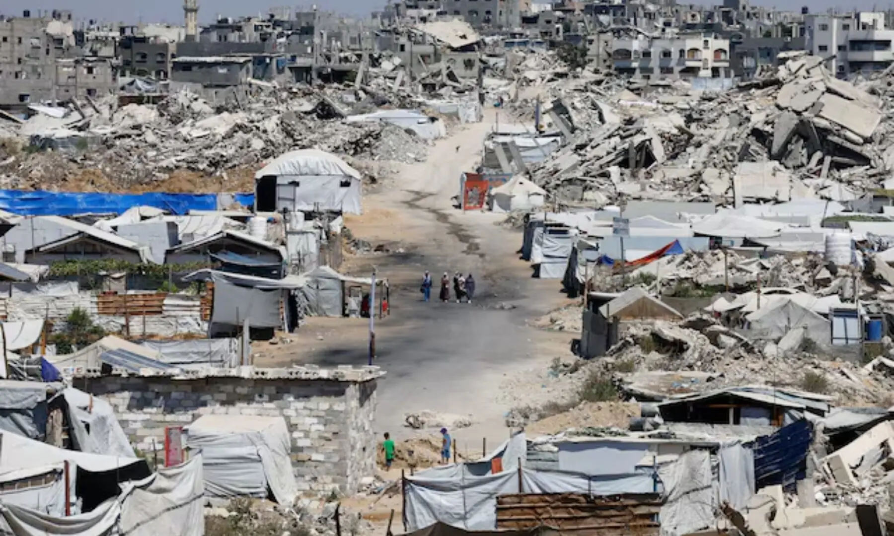 People walk at a site destroyed during the Israeli offensive, in Beit Lahiya, in the northern Gaza Strip on August 18, 2026. —Reuters/File People walk at a site destroyed during the Israeli offensive, in Beit Lahiya, in the northern Gaza Strip on August 18, 2026. —Reuters/File