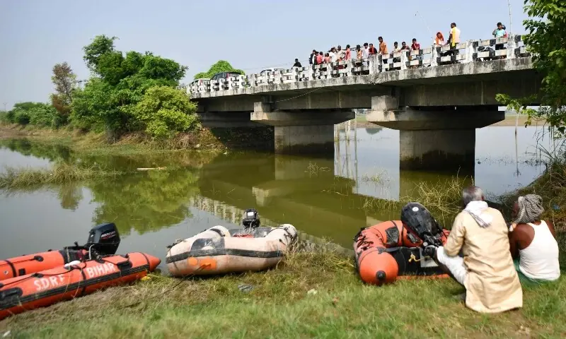 People watch from a bridge as rescue personnel conduct a search operation for the missing after a boat capsized in Ganga river in Bihar's Vaishali district on October 14, 2026. —AFP People watch from a bridge as rescue personnel conduct a search operation for the missing after a boat capsized in Ganga river in Bihar's Vaishali district on October 14, 2026. —AFP