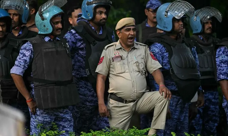 A Delhi police personnel yawns as security personnel gather during a protest by student activists demanding the resignation of the nation's Chief Election Commissioner Gyanesh Kumar over alleged voter roll irregularities linked to the “special intensive revision” (SIR), in New Delhi on October 14, 2026. —AFP A Delhi police personnel yawns as security personnel gather during a protest by student activists demanding the resignation of the nation's Chief Election Commissioner Gyanesh Kumar over alleged voter roll irregularities linked to the “special intensive revision” (SIR), in New Delhi on October 14, 2026. —AFP