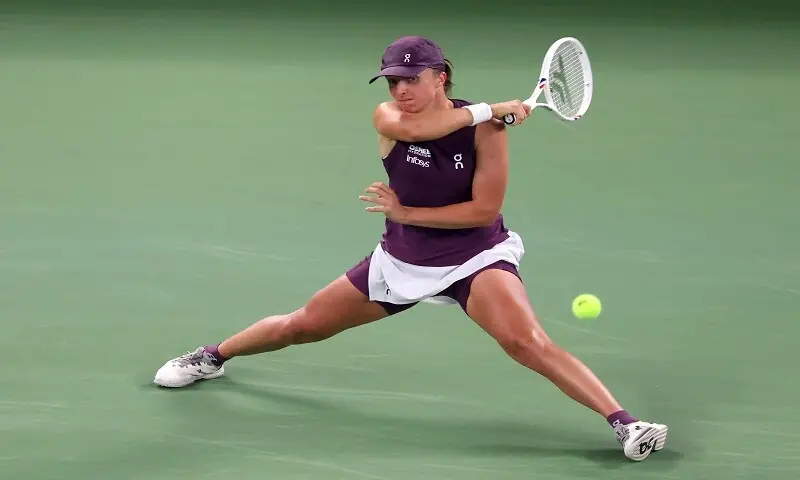 Poland's Iga Swiatek hits a return against Ann Li of the US during their Wuhan Open quarter-final at the Optics Valley International Tennis Center in Wuhan, China on October 16, 2026. —Reuters Poland's Iga Swiatek hits a return against Ann Li of the US during their Wuhan Open quarter-final at the Optics Valley International Tennis Center in Wuhan, China on October 16, 2026. —Reuters