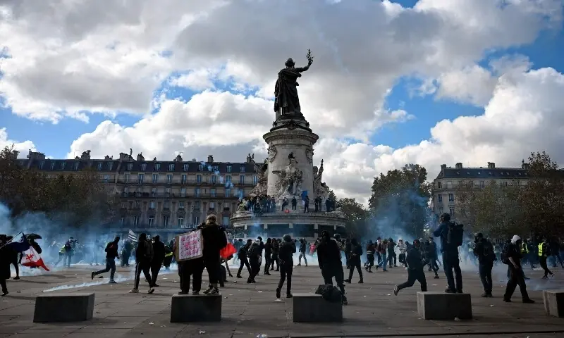 Protesters stand amid tear gas smoke as clashes erupt ahead of a demonstration to protest against the “high cost of living”, at Place de la Republique in Paris, France on October 17, 2026. — AFP