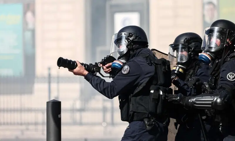 A French national police officer fires tear gas during clashes prior to the start of a demonstration to protest against the “high cost of living”, in Marseille, southern France on October 17, 2026. — AFP