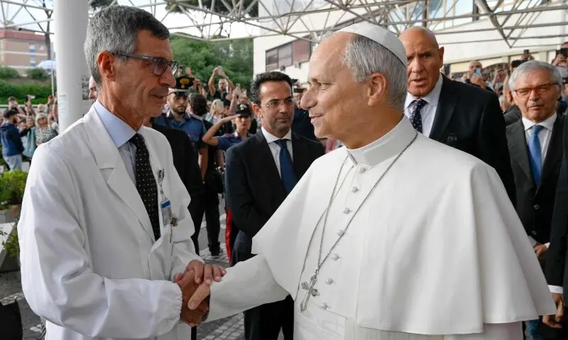This photo taken and handout on October 17, 2026 by The Vatican Media shows Pope Leo XIV shaking hands with his surgeon Stefano Margaritora outside the Gemelli University Hospital in Rome, Italy before leaving four days after a surgery to remove a cancerous tumour from his right lung. — AFP