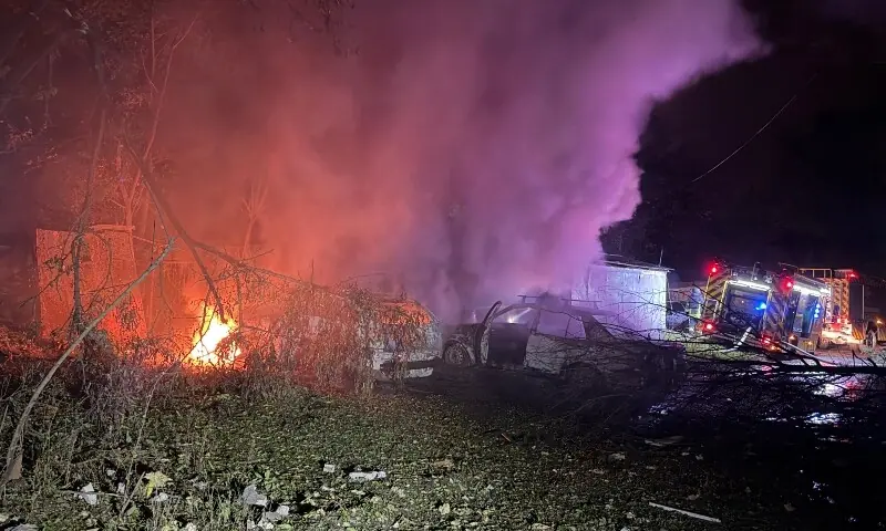 Rescuers put out a fire outside a residential building damaged following a Russian missile attack in Zaporizhzhia, Ukraine on October 17, 2026. — AFP