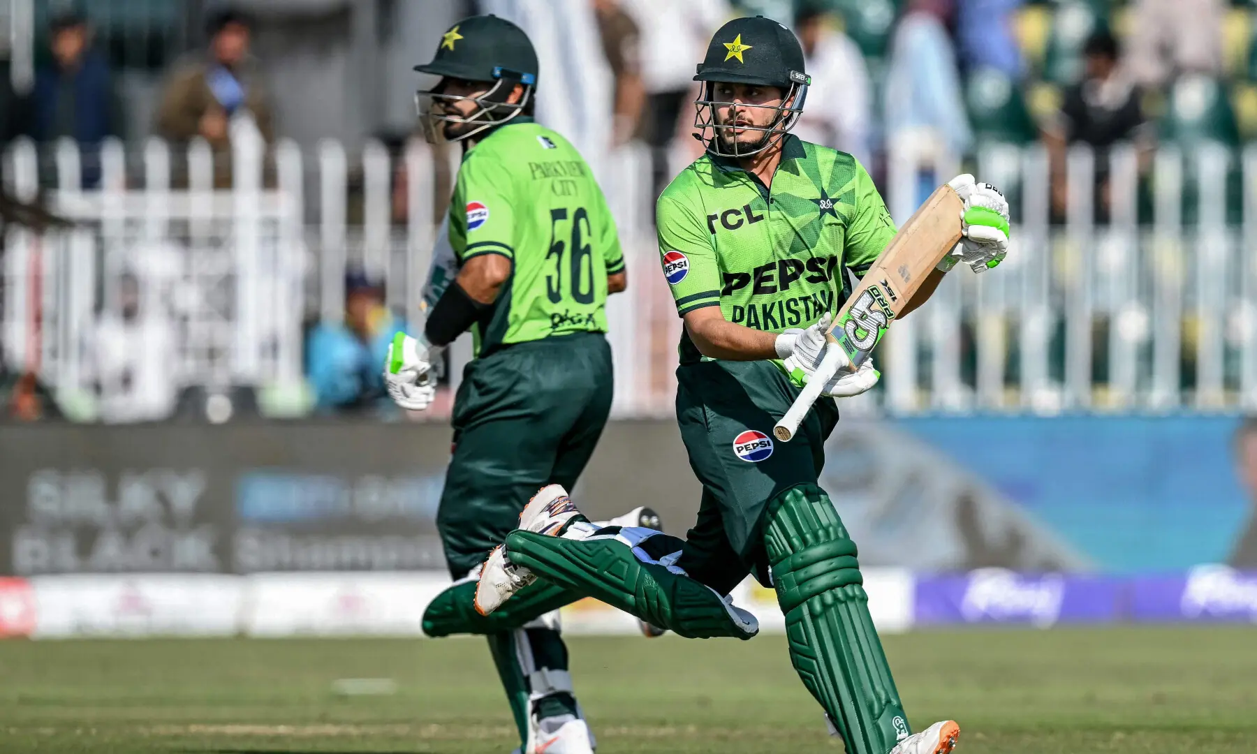 Saad Baig (R) and Babar Azam run between the wickets during the tri-series ODI cricket match between Pakistan and Sri Lanka at the Rawalpindi Cricket Stadium in Rawalpindi on Oct 18, 2026. &mdash; AFP