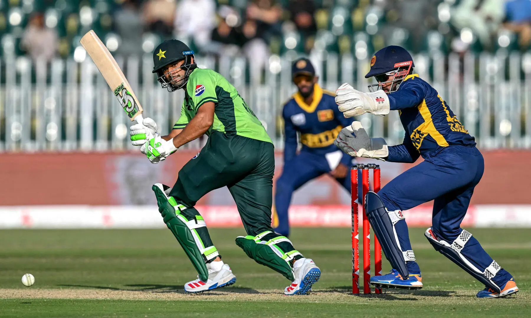 Hasan Nawaz (L) watches the ball after playing a shot during the tri-series ODI match between Pakistan and Sri Lanka at the Rawalpindi Cricket Stadium in Rawalpindi on Oct 18, 2026. &mdash; AFP