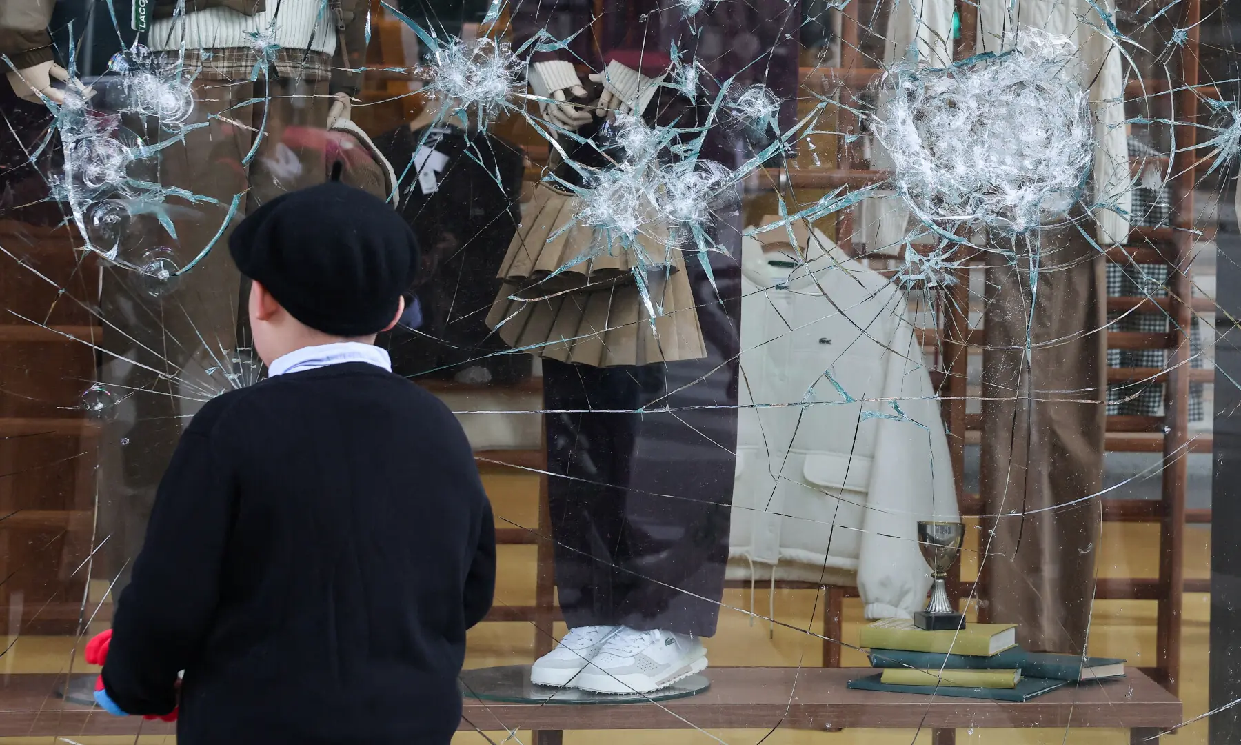  Damaged glass at the Lacoste store on Champs-&Eacute;lys&eacute;es Avenue, the day after clashes during a national day of demonstrations against the cost of living and rising fuel prices, in Paris, France on Oct 18. &mdash; Reuters 