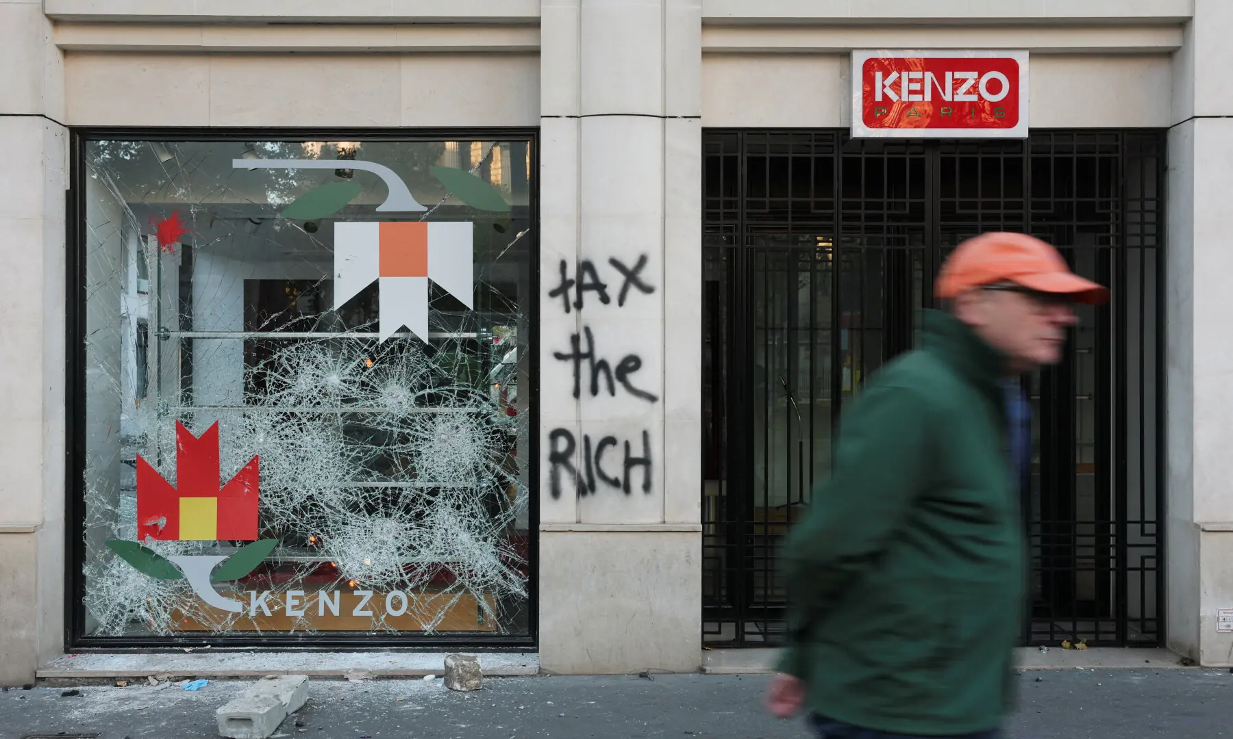  A man walks past a vandalised Kenzo store, the day after clashes during a national day of demonstrations against the cost of living and rising fuel prices, in Paris, France, on Oct 18. &mdash; Reuters 