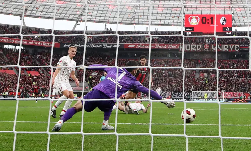 LEVERKUSEN: Bayer Leverkusen’s Ibrahim Maza (R) scores during the Bundesliga match against Freiburg at BayArena on Sunday.—Reuters LEVERKUSEN: Bayer Leverkusen’s Ibrahim Maza (R) scores during the Bundesliga match against Freiburg at BayArena on Sunday.—Reuters
