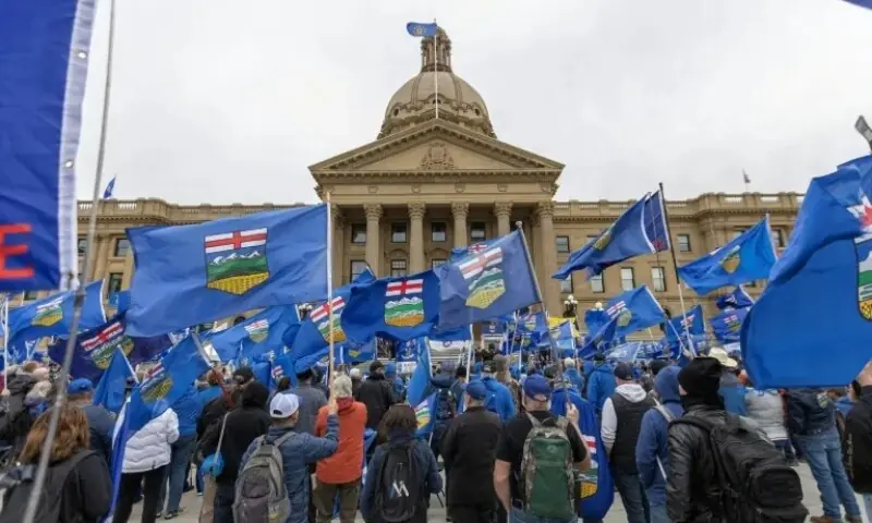 Supporters of Alberta separating from Canada held a banner and flags during a rally in May. &mdash;AFP/File