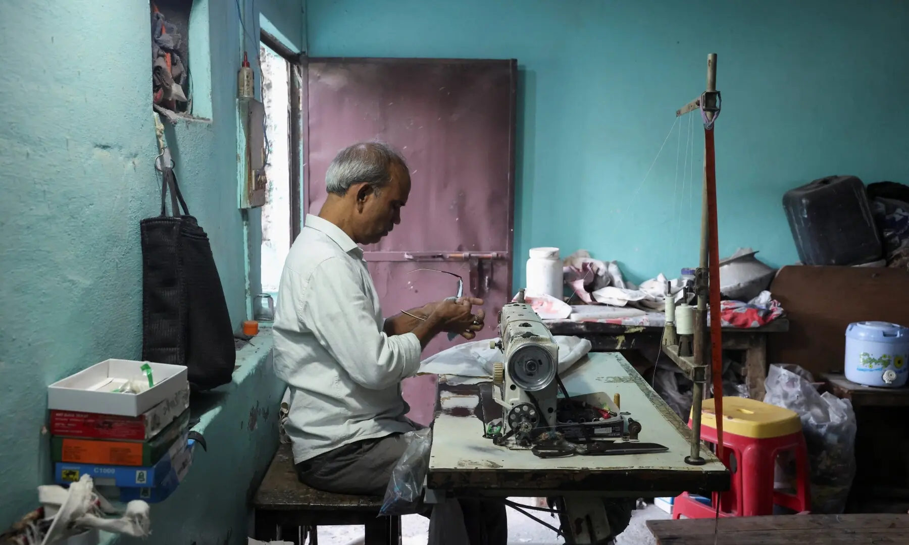 Kamta Prasad, 53, a voter who is listed as “Kanta Prasad” and is declared dead in the Special Intensive Revision (SIR) list published on August 1, 2026, cleans his glasses at his workstation, in New Delhi, India on October 19, 2026. —Reuters