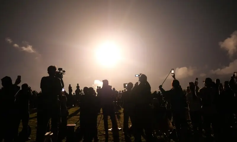 People watch the launch of the H3 rocket, carrying the Martian Moons eXploration (MMX) spacecraft, at the Tanegashima Space Center in Kagoshima Prefecture on October 20, 2026. —AFP