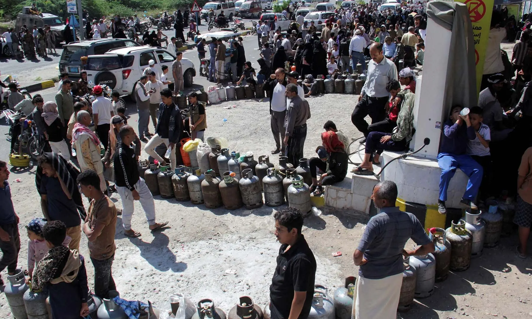 People wait outside a gas station to fill up cooking gas cylinders in the southwestern city of Taiz, Yemen on October 19, 2026. &mdash; Reuters