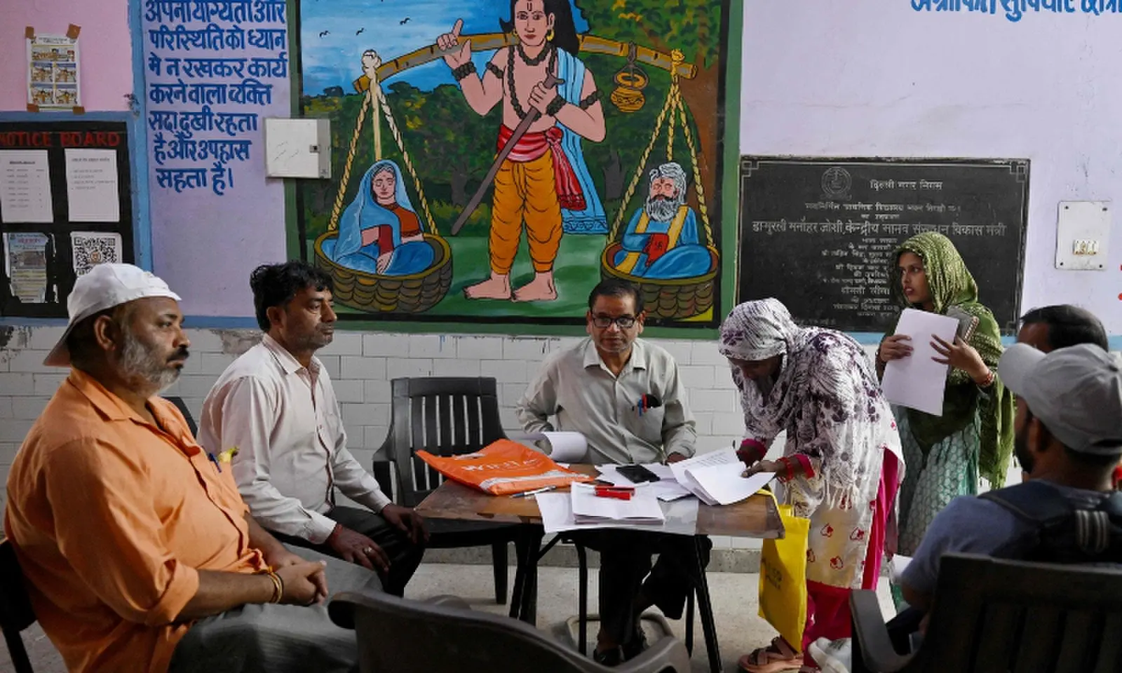 Booth level-officer (BLO) Mukesh Khanna (3L) assists Laddli Khatun (3R), a slum dweller to register for the Draft Electoral Roll 2026 as part of the Election Commission of India's Special Intensive Revision (SIR), at a voter verification camp in New Delhi on October 18, 2026. —AFP Booth level-officer (BLO) Mukesh Khanna (3L) assists Laddli Khatun (3R), a slum dweller to register for the Draft Electoral Roll 2026 as part of the Election Commission of India's Special Intensive Revision (SIR), at a voter verification camp in New Delhi on October 18, 2026. —AFP