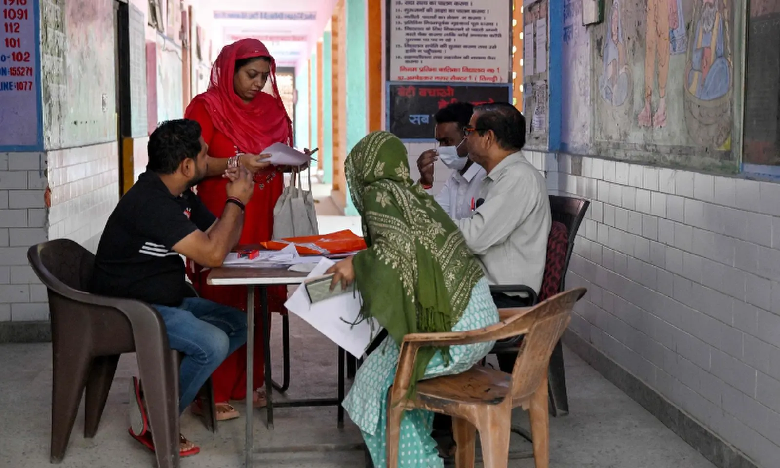 Booth level-officer (BLO) Mukesh Khanna (R) assists people to register their documents for the Draft Electoral Roll 2026 as part of the Election Commission of India’s Special Intensive Revision (SIR), at a voter verification camp in New Delhi on October 18, 2026. —AFP