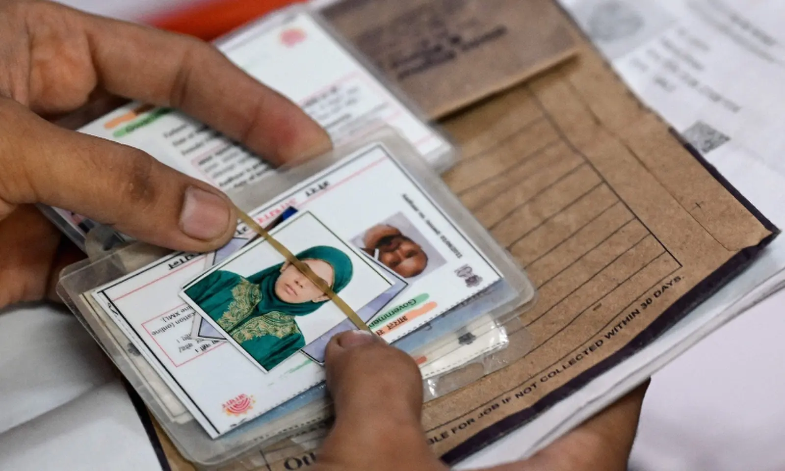 A man waits with documents to register for the Draft Electoral Roll 2026 as part of the Election Commission of India’s Special Intensive Revision (SIR), at a voter verification camp in New Delhi on October 18, 2026. —AFP
