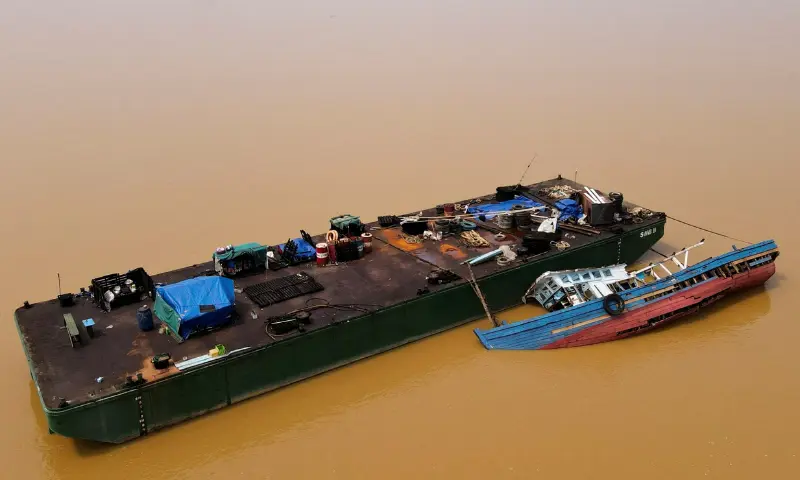 A drone view shows a partially submerged tugboat alongside a barge on the Kapuas River as water levels recede amid a prolonged El Ni&ntilde;o-induced drought in Sanggau Regency, West Kalimantan province, Indonesia, on September 30, 2026. &mdash; Reuters/File