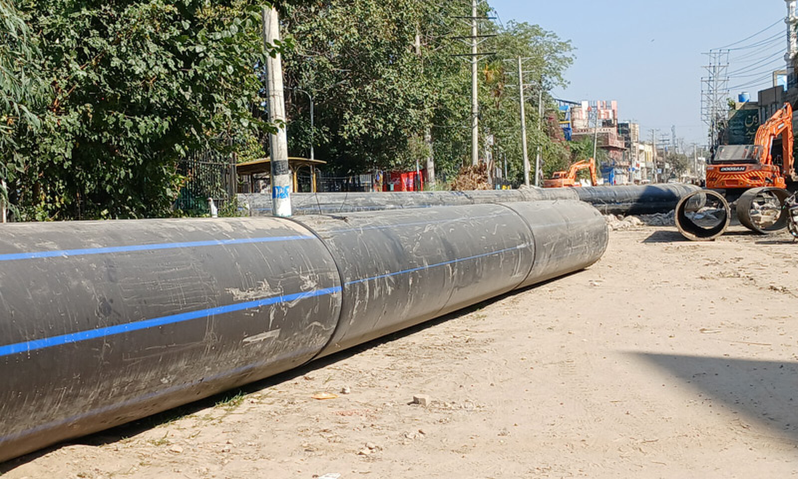 GUJRAT: Pipes lying on Jalalpur Jattan Road near Kutchery Chowk causing inconvenience to motorists. &mdash; Dawn