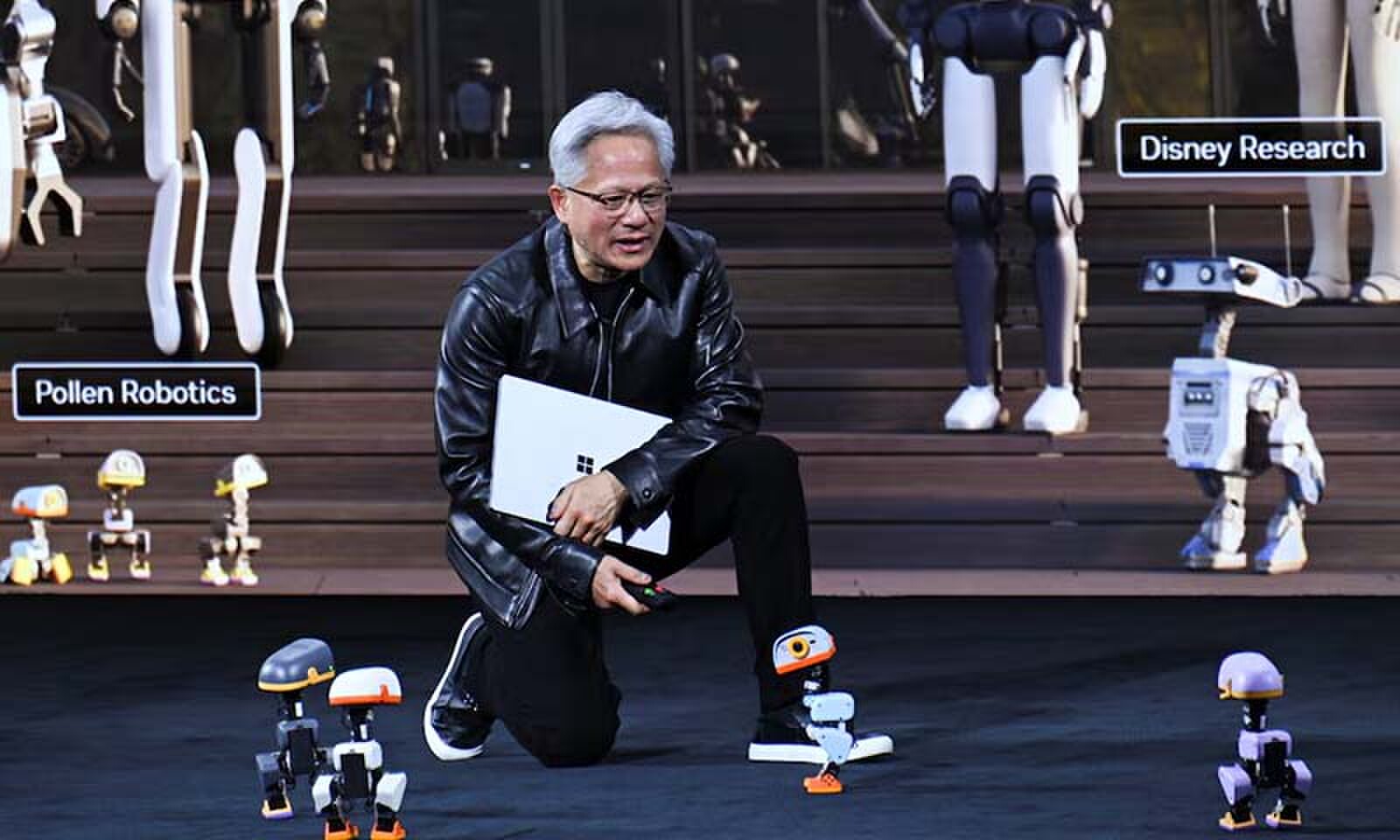 NVIDIA CEO Jensen Huang speaks to Microducks, 25cm-tall biped robots, during his keynote at the NVIDIA GTC conference in Berlin, Germany on October 21, 2026. &mdash; Reuters