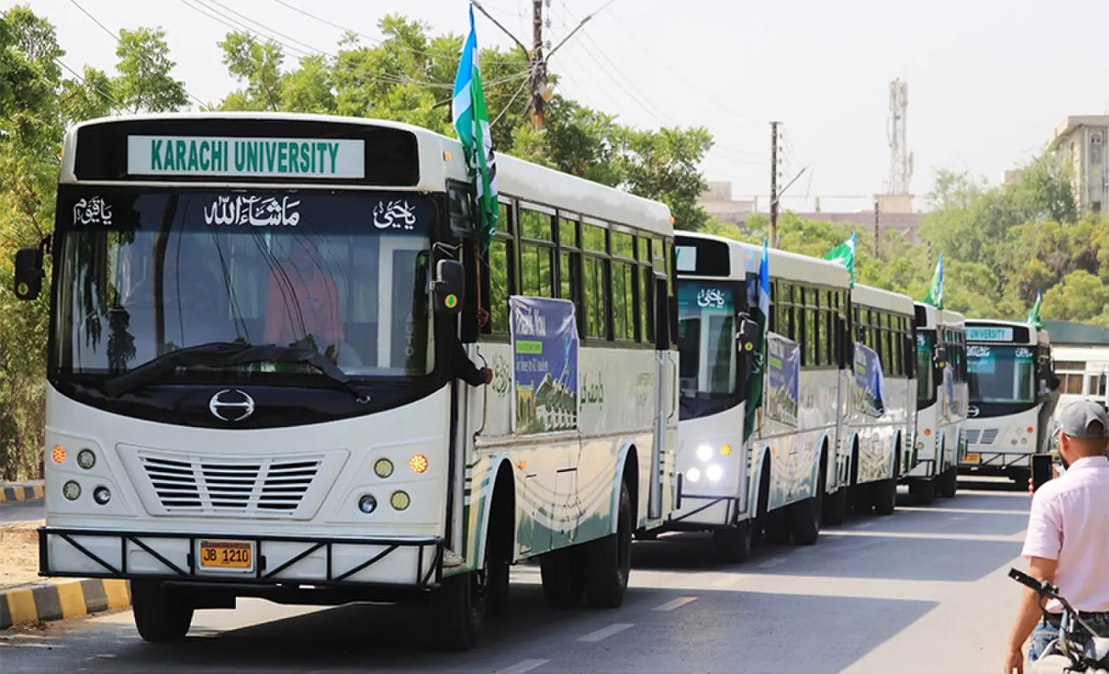The refurbished buses enter the University of Karachi.&mdash;Dawn