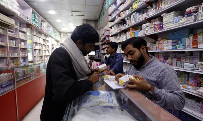 A customer buys medicine from a medical supply store in Karachi, Pakistan, on February 9, 2023. &mdash; Reuters/File