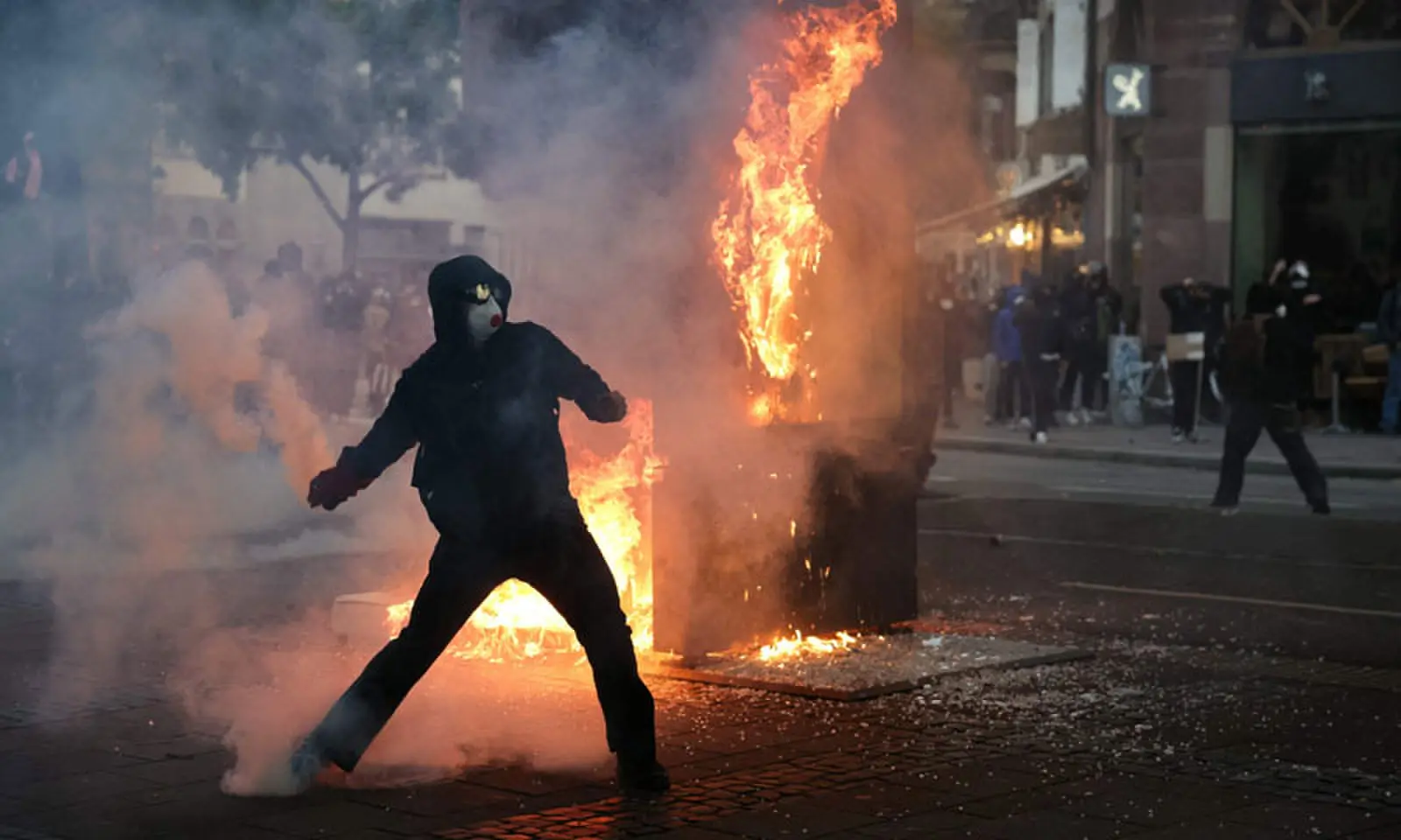 A PROTESTER throws back a tear gas canister during a demonstration against the rising cost of living in Strasbourg.&mdash;AFP