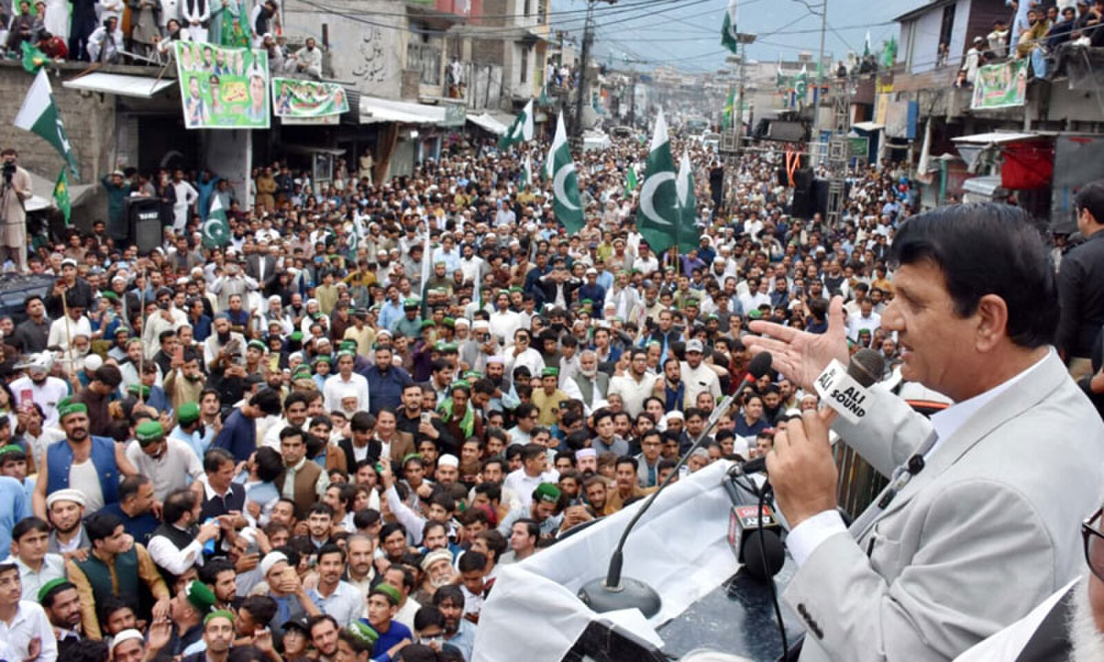 Federal minister Amir Muqam addresses a public meeting in Shangla on Sunday. &mdash; Dawn