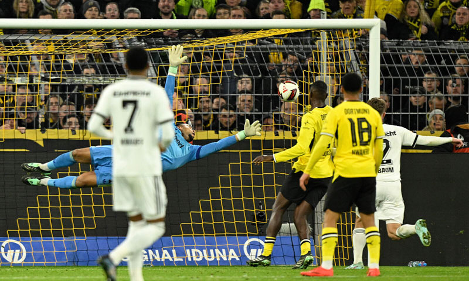 Eintracht Frankfurt goalkeeper Noah Atubolu dives but fails to save the shot by Dortmund&rsquo;s Maximilian Beier (not in picture) during their Bundesliga match.&mdash;AFP