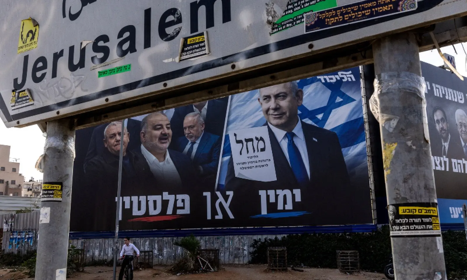 A boy sits on his bicycle next to a campaign banner of Netanyahu's Likud party, ahead of the Israeli parliamentary election, in Bnei Brak, Israel on October 25, 2026. &mdash;Reuters
