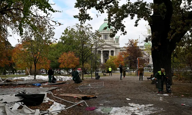 Street cleaning workers clear away the remains of tents and rubbish from a pro-government encampment in a park opposite the Serbian Parliament in Belgrade on Oct 26, 2026, after crowds celebrating election results entered the site the previous night and dismantled tents that had occupied the area for months, setting them alight along with a number of cars. — AFP Street cleaning workers clear away the remains of tents and rubbish from a pro-government encampment in a park opposite the Serbian Parliament in Belgrade on Oct 26, 2026, after crowds celebrating election results entered the site the previous night and dismantled tents that had occupied the area for months, setting them alight along with a number of cars. — AFP