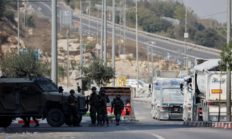 Israeli soldiers block a road during a military operation in Hebron in the Israel-occupied West Bank, on Oct 25, 2026. &mdash; Reuters
