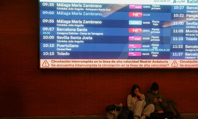 Two people sit below an information screen with a message stating that the high-speed train line between Madrid and Andalucia has been interrupted following the collision of two high-speed trains between the towns of Mora and Orgaz, at the Atocha train station in Madrid, Spain, October 28, 2026. — Reuters Two people sit below an information screen with a message stating that the high-speed train line between Madrid and Andalucia has been interrupted following the collision of two high-speed trains between the towns of Mora and Orgaz, at the Atocha train station in Madrid, Spain, October 28, 2026. — Reuters