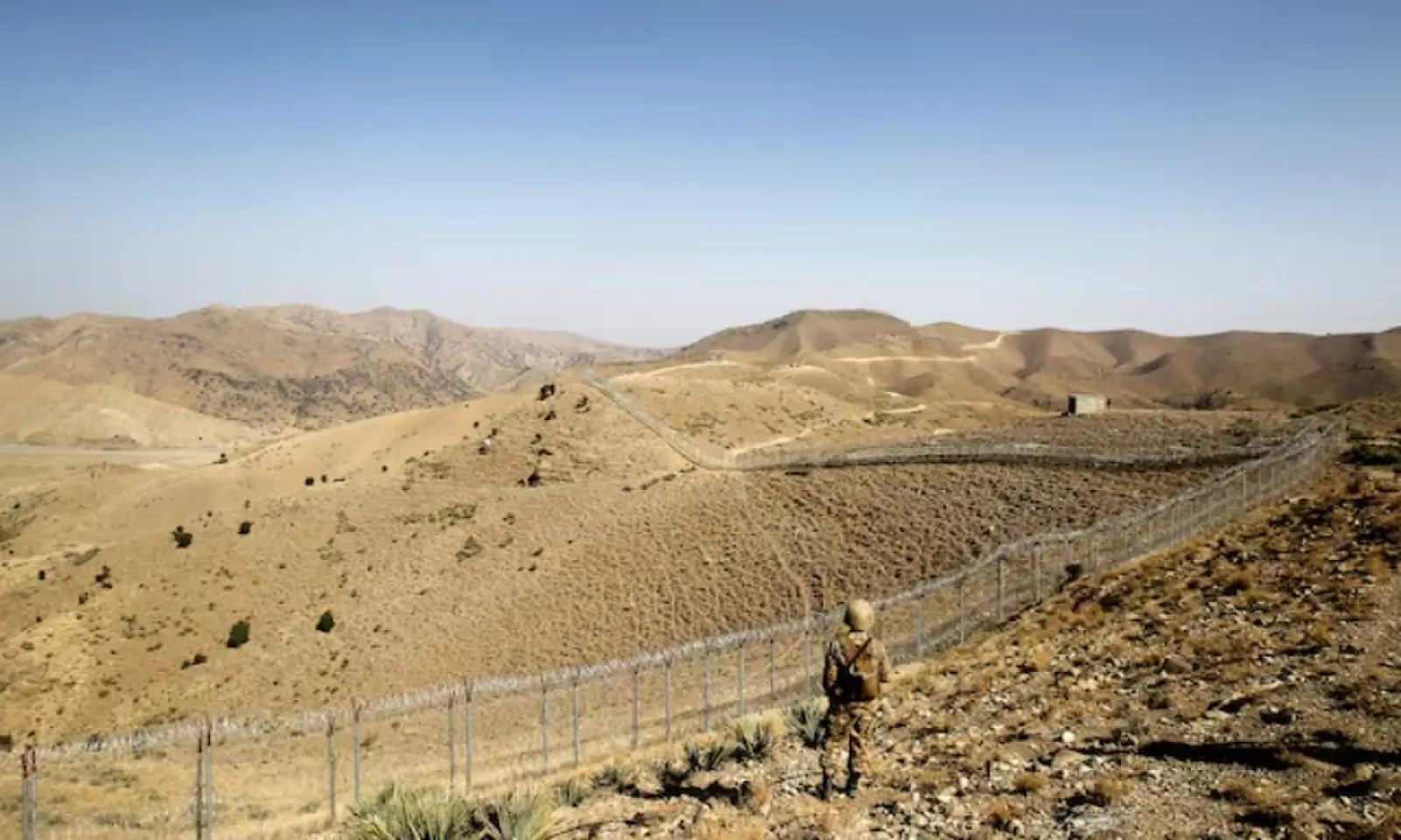 A soldier stands guard along the border fence outside the Kitton outpost on the border with Afghanistan in North Waziristan, Pakistan October 18, 2017. &mdash; Reuters