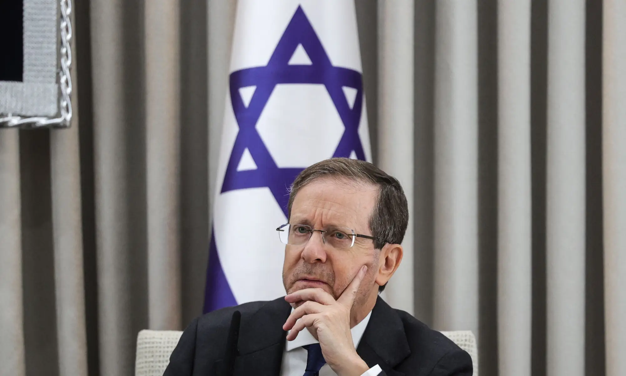 Israel's President Isaac Herzog looks on during a meeting with the German Chancellor at his residence in Jerusalem on December 6, 2025. &mdash; Pool via AFP/File