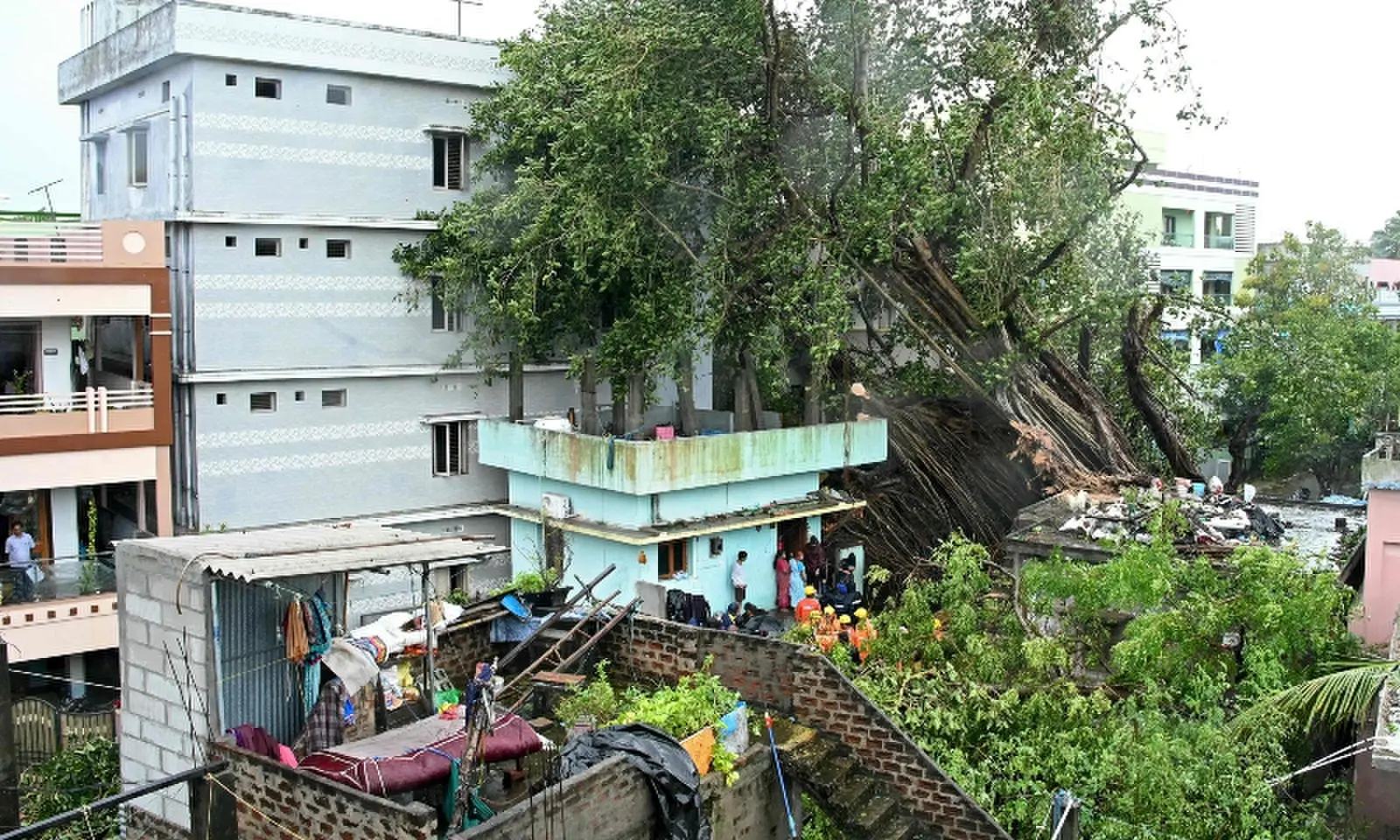 National Disaster Response Force (NDRF) personnel gather near houses damaged by uprooted trees after cyclone Arnab's landfall in Yanam, in India's Puducherry on October 28, 2026. —AFP National Disaster Response Force (NDRF) personnel gather near houses damaged by uprooted trees after cyclone Arnab's landfall in Yanam, in India's Puducherry on October 28, 2026. —AFP