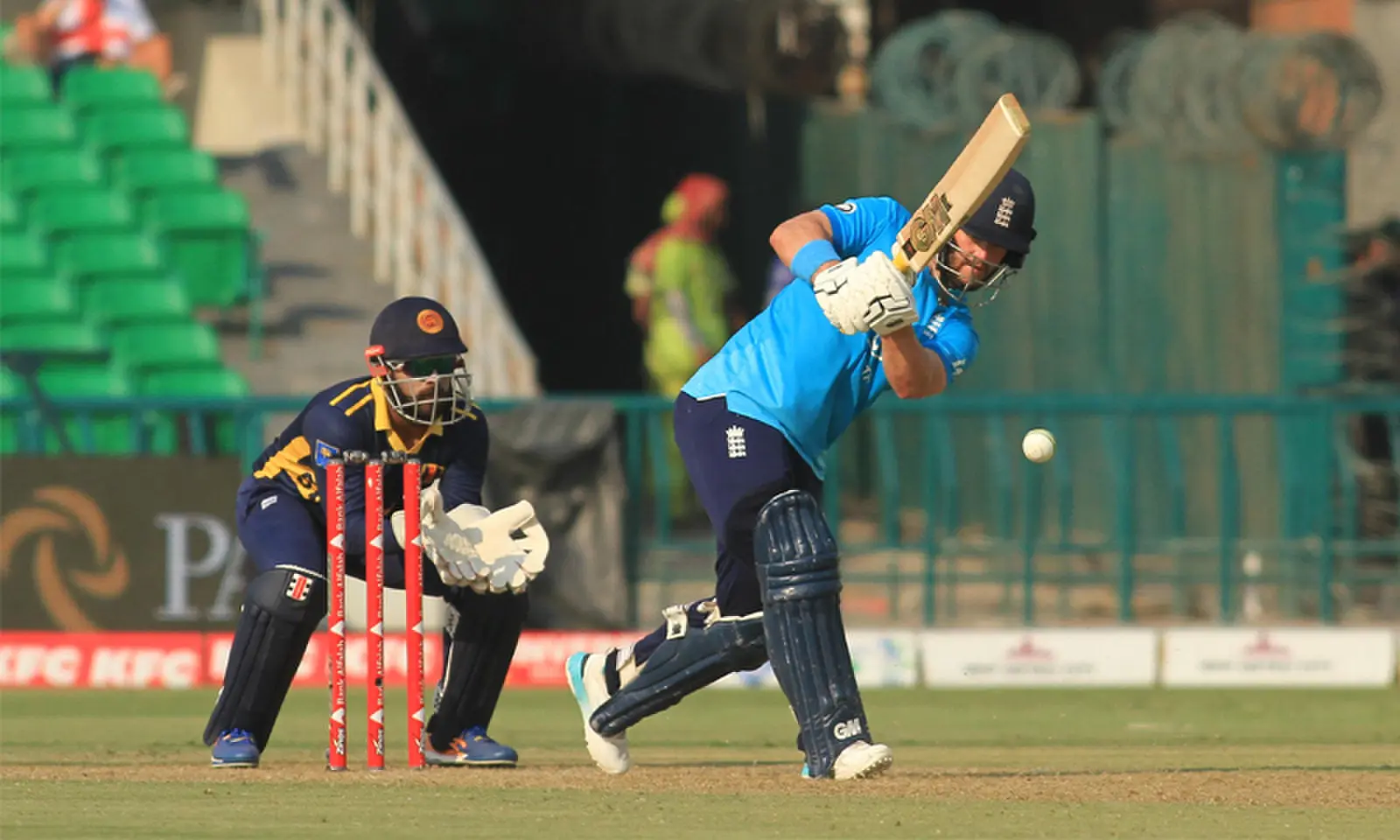 LAHORE: England opener Ben Duckett plays a stroke as Sri Lankan captain Kusal Mendis looks on during their ODI tri-series match at the Gaddafi Stadium on Thursday.—M. Arif/White Star LAHORE: England opener Ben Duckett plays a stroke as Sri Lankan captain Kusal Mendis looks on during their ODI tri-series match at the Gaddafi Stadium on Thursday.—M. Arif/White Star