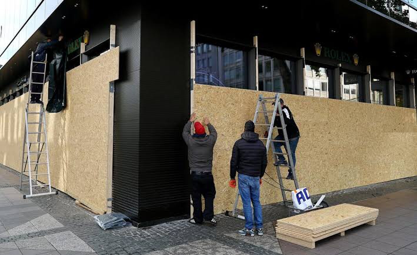 A worker secures a fashion store with wooden boards ahead of expected protests by the youth movement “Gen Z regelt” in Frankfurt, Germany, October 30, 2026. —Reuters A worker secures a fashion store with wooden boards ahead of expected protests by the youth movement “Gen Z regelt” in Frankfurt, Germany, October 30, 2026. —Reuters