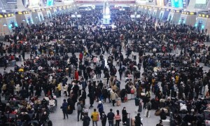 China plays down Covid outbreak with holiday rush at full tilt