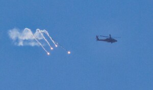 PHOTOS: Israeli army helicopter fires flares over Gaza Strip amid ongoing military operation