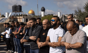 Palestinians barred from Al-Aqsa pray on the street