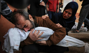 PHOTOS: People in Gaza wait their turn to identify bodies of loved ones killed in Israeli bombing