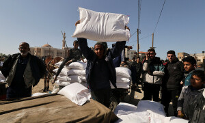 PHOTOS: Palestinians gather in south Gaza to receive flour distributed by UN agency