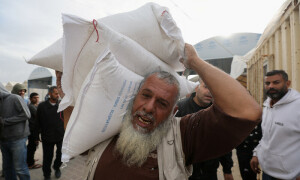 PHOTOS: Palestinians gather to receive flour bags in southern Gaza amid truce