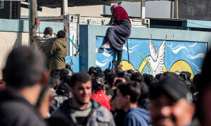 PHOTOS: Palestinians wait to receive flour rations outside UNRWA warehouse in Rafah