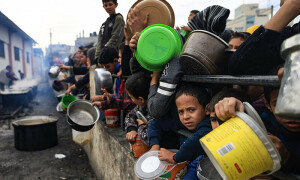 PHOTOS: Palestinians wait to collect food at donation point in Rafah