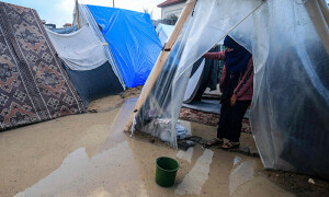 PHOTOS: Displaced Palestinians grapple with floods in tent camp after heavy rain