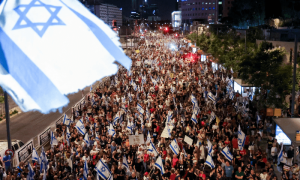 Waving flags, tens of thousands rally in Tel Aviv against Israeli govt